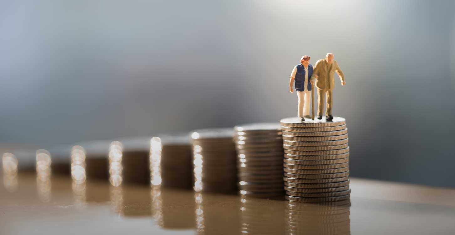 Old couple figure standing on top of coin stack