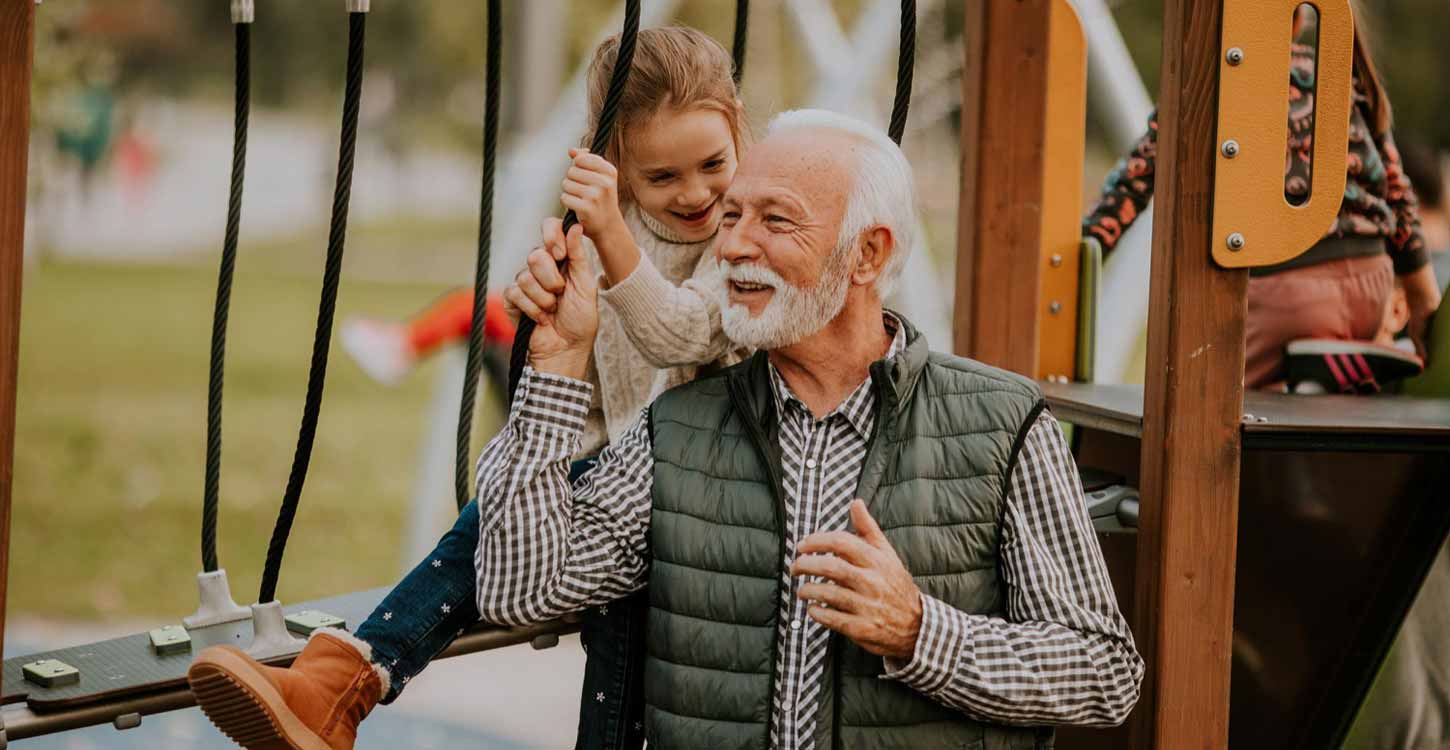 grandfather spending time with his granddaughter at the park